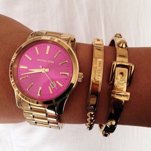 Loving this Michael Kors gold watch with a hot pink face for that .